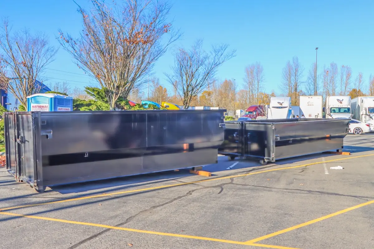 Professional dumpster rental service with roll-off container on residential driveway in Mililani Town